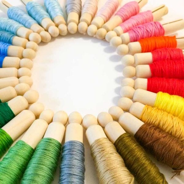 Floss on wooden dolly pegs